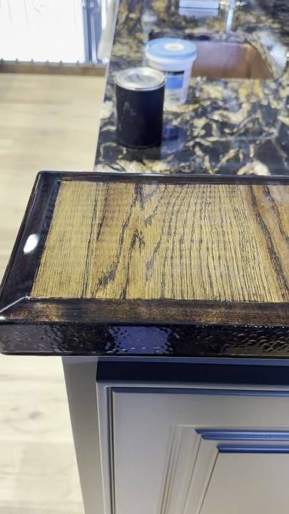 Edge of an oak bar top with a thick clear epoxy coat