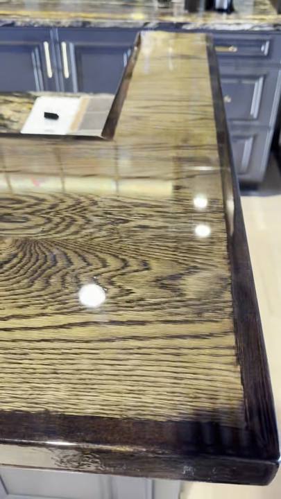 Long oak bar top under a glossy clear epoxy coat