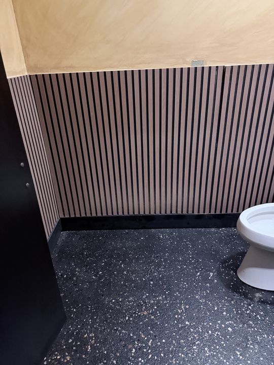 Commercial restroom with a dark flake epoxy floor