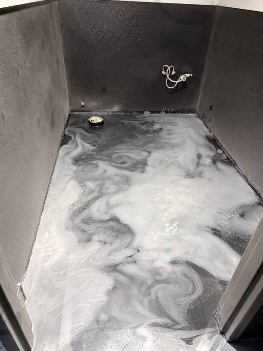 Second view of a silver metallic epoxy restroom floor