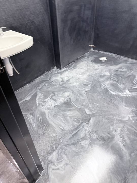 Silver metallic epoxy floor in a commercial restroom