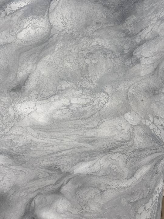 Close-up of a swirled white and gray metallic epoxy floor