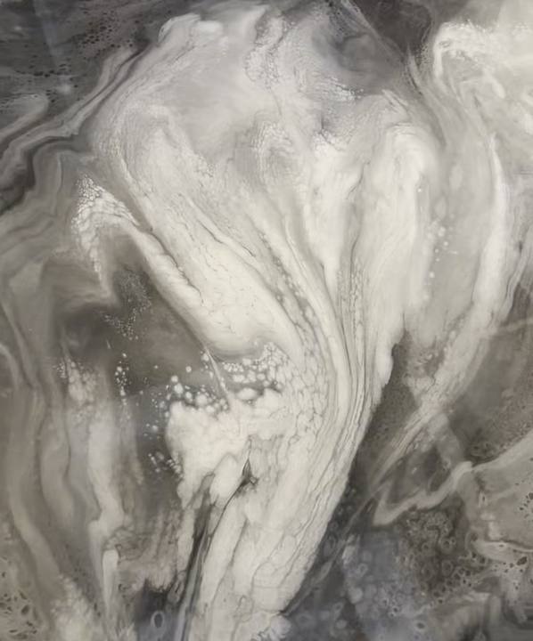 Close-up of white, silver and charcoal swirls in a metallic epoxy floor