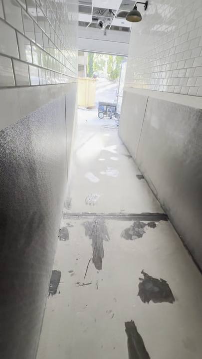 Corridor with patched cracks and holes before coating